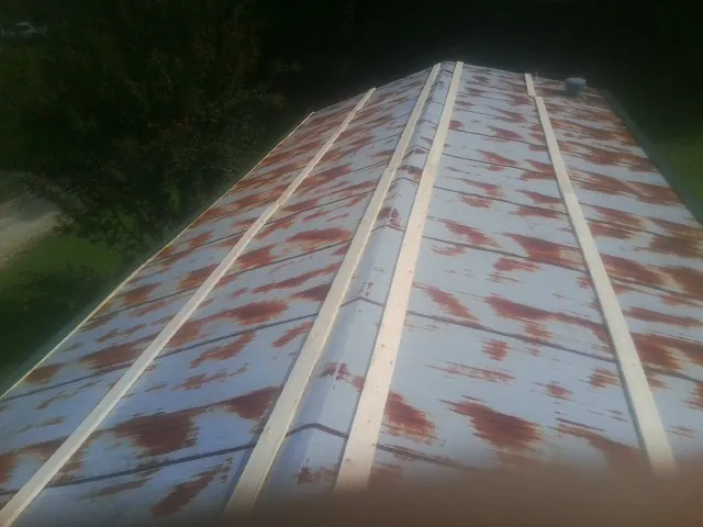 Rusted metal roof panels with new wood purlins before replacement — Storm Damage Roof Repair in Millstone Township by Roofing Brothers