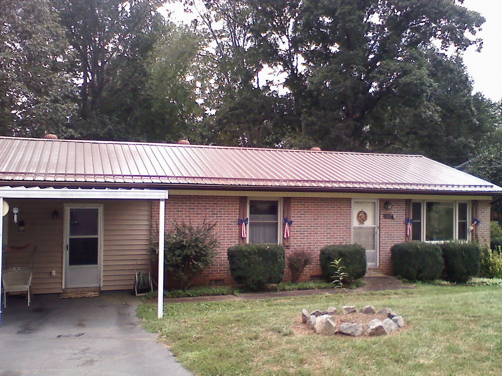 Bronze metal roof and carport on a brick ranch home — Roof Repair work by our crew in Millstone Township